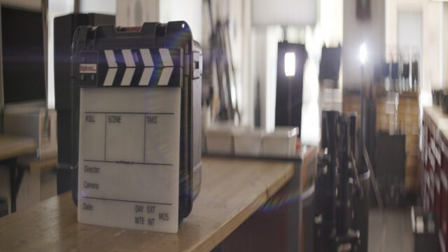 A slate in front of a window and lights, squeezed by an anamorphic lens