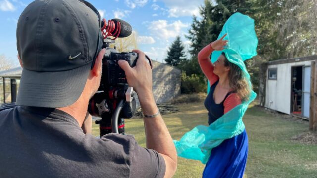 Woman dancing with scarf in fron of camera