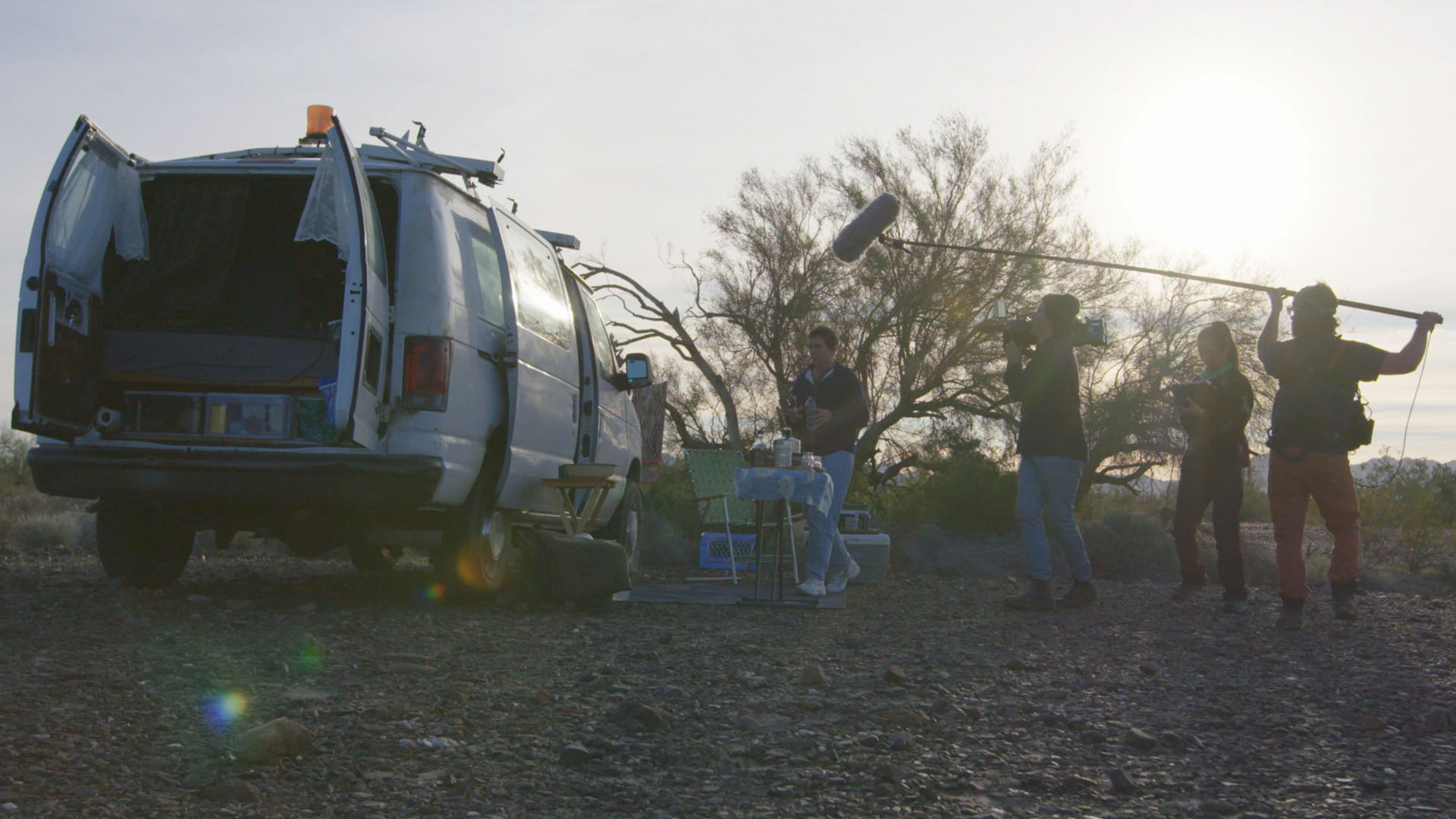 A core crew shoots the scene with Fern and the van.