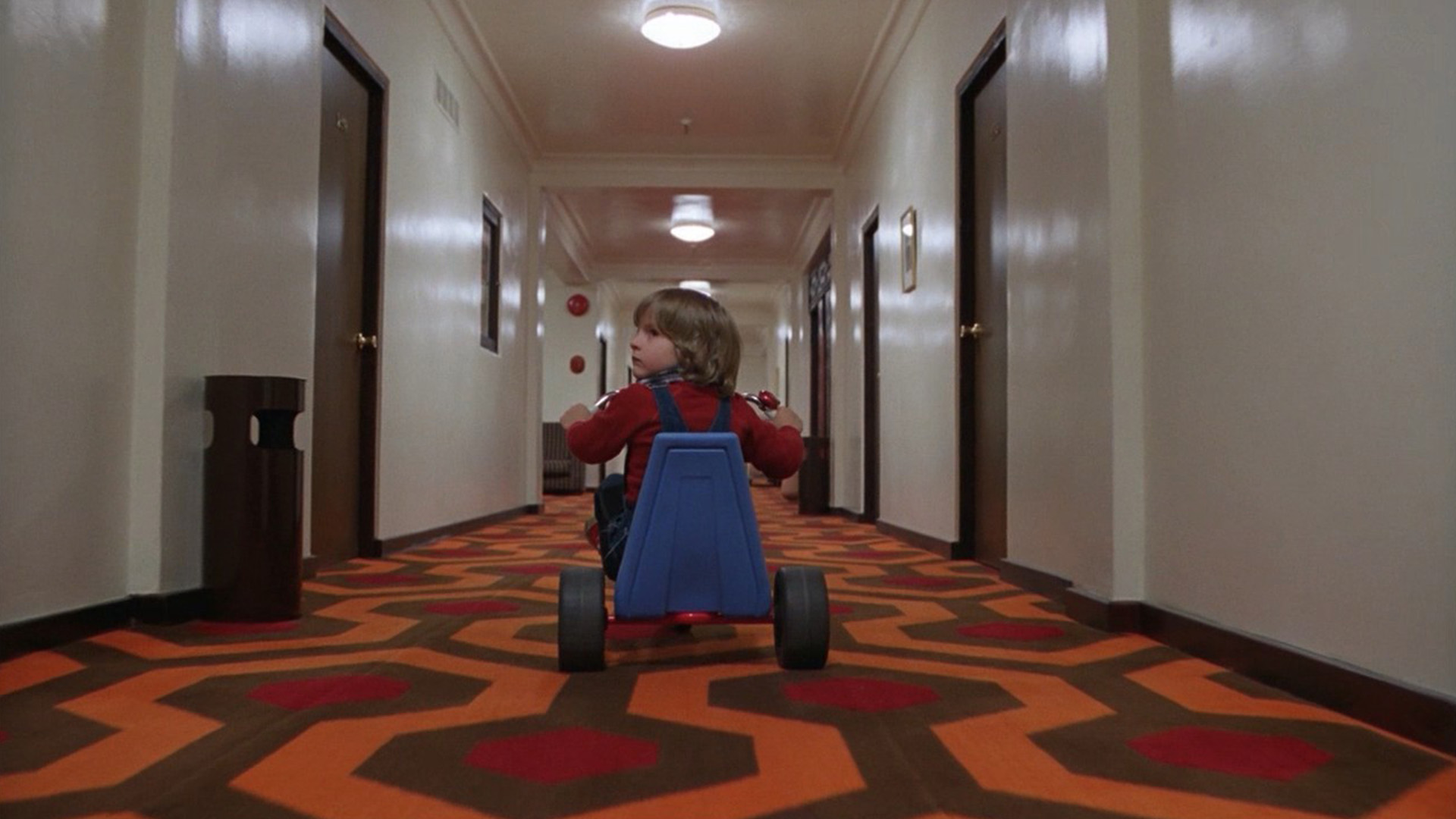 The film still from the scene where Danny rides his bicycle through the hotel hallway.