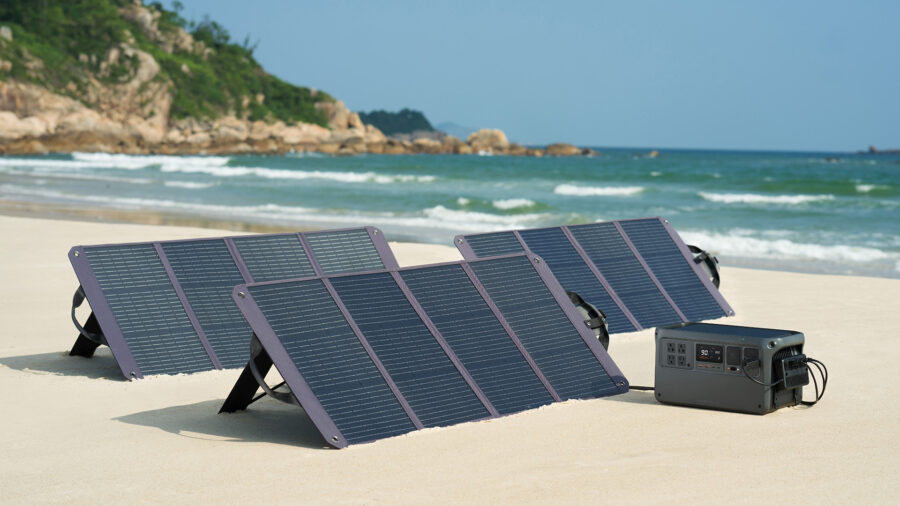 DJI Power 1000 V2 battery block charging with lots of solar panels on a beautiful beach